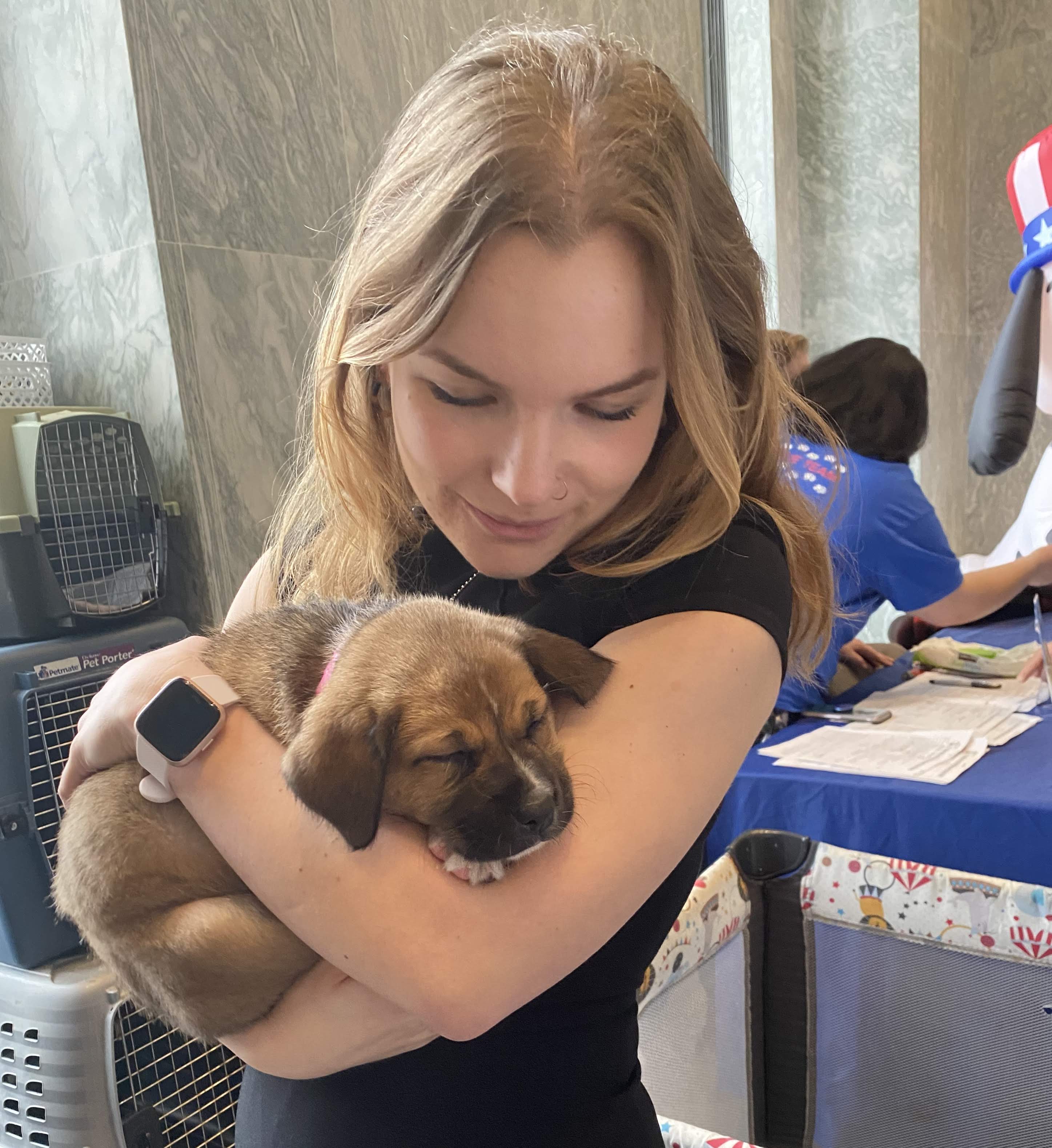 Elise with a puppy at the ASPCA Puppy Love Event
