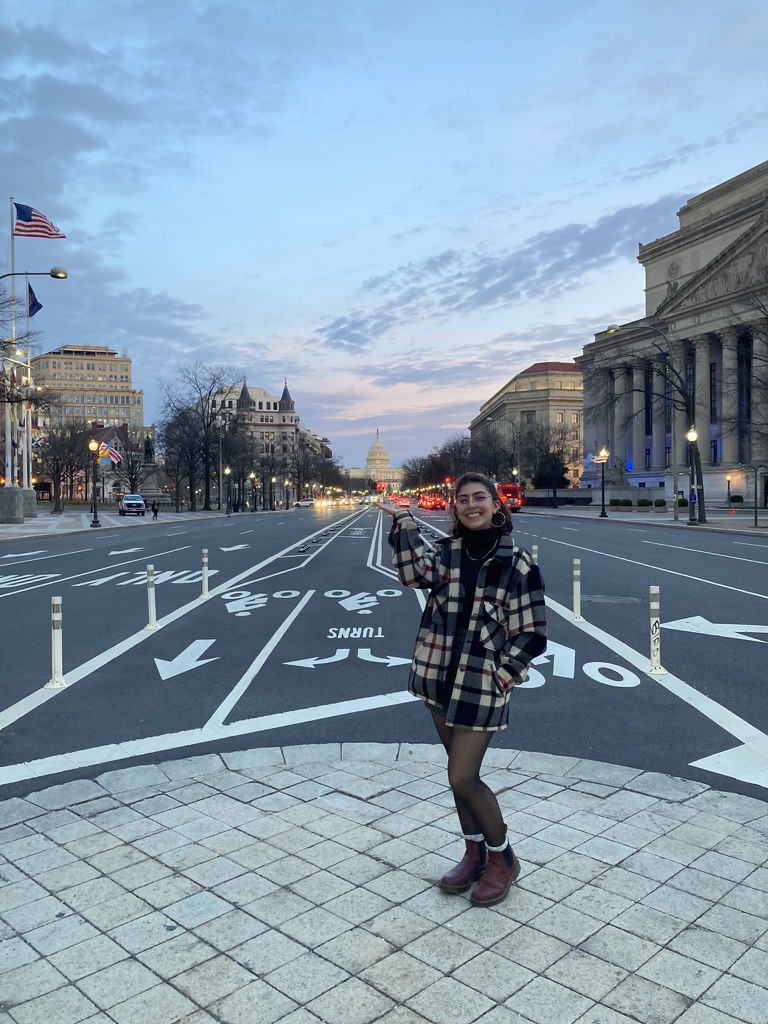 Photo of Liliana Hazel posing on a sidewalk overlooking an empty street