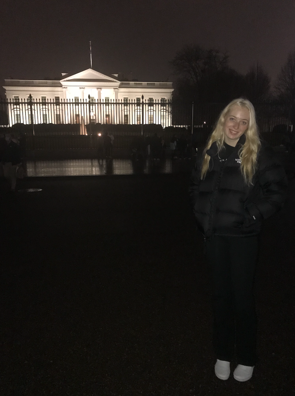 Layla Mitchell at night standing near the White House