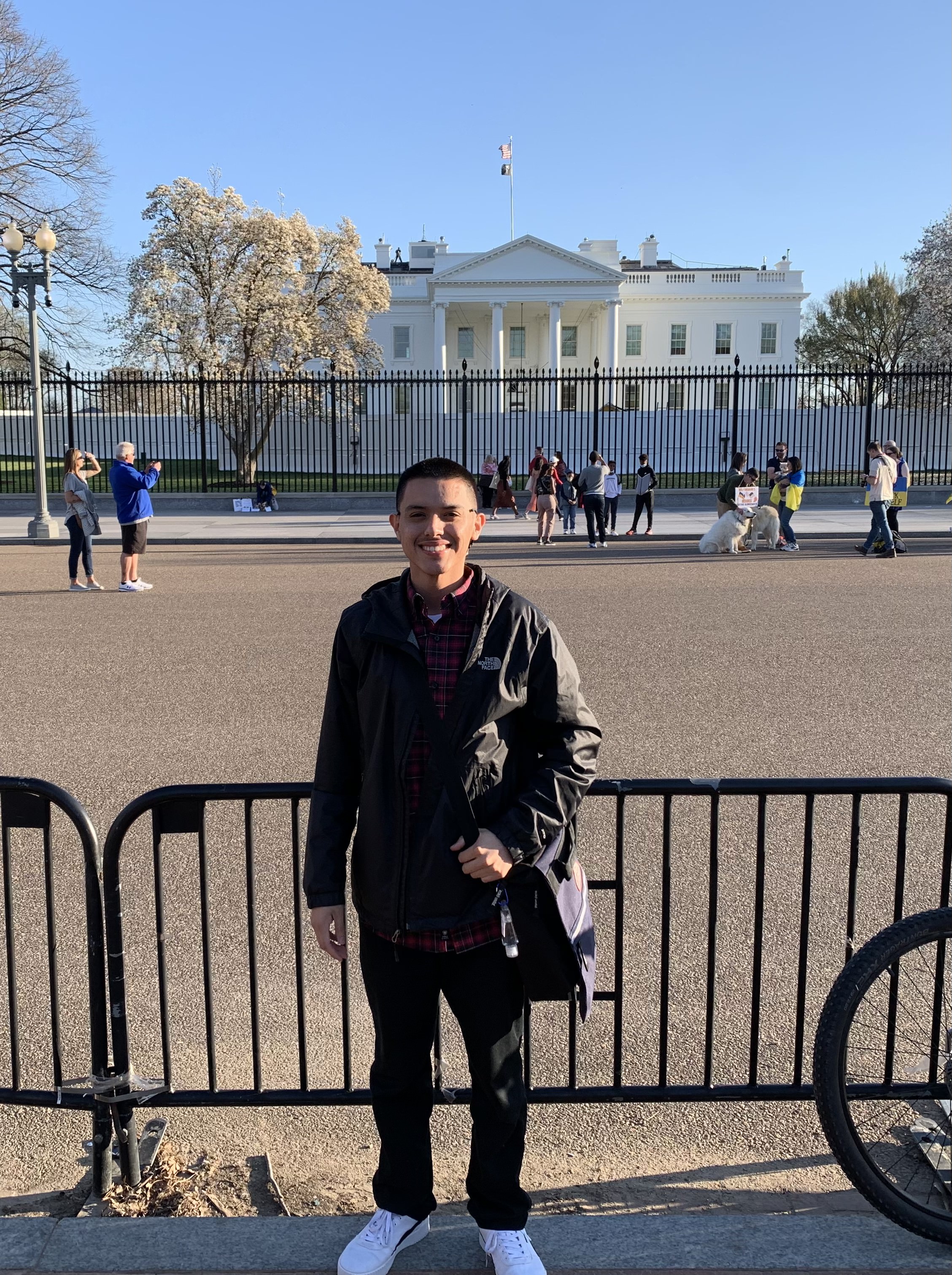 Photo of Hipolito Angel Cerros standing on the sidewalk with the White House in the distance