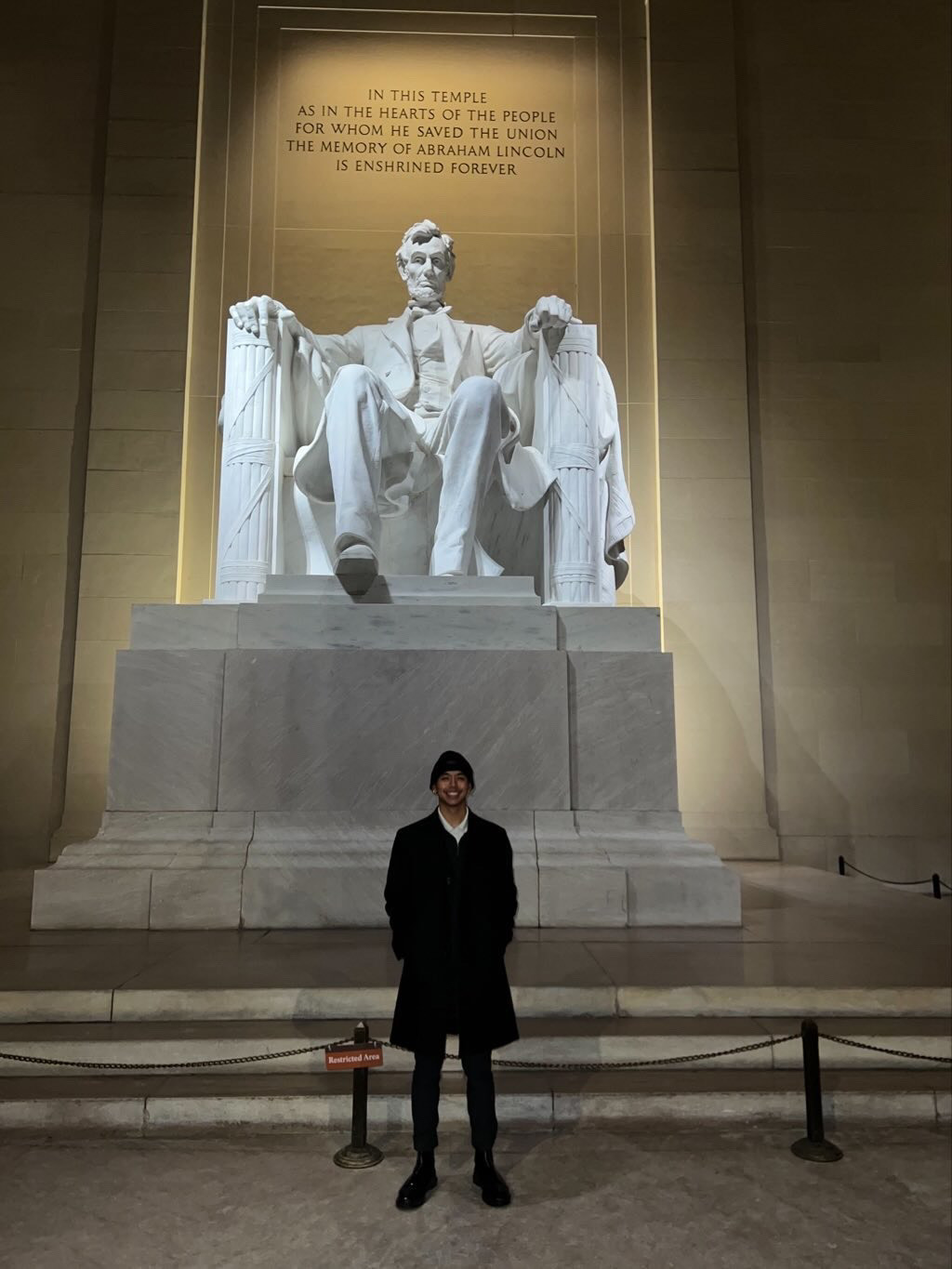 Jordan standing in front of the Lincoln Memorial at night