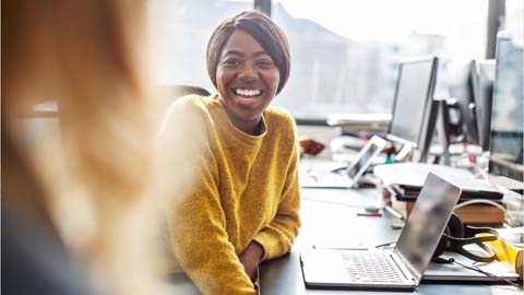 Smiling woman with laptop