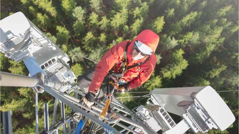Person climbing telecommunications tower