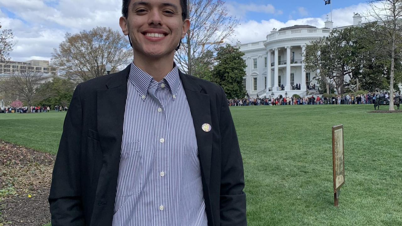 Headshot of Hipolito Angel Cerros in front of the White House lawn