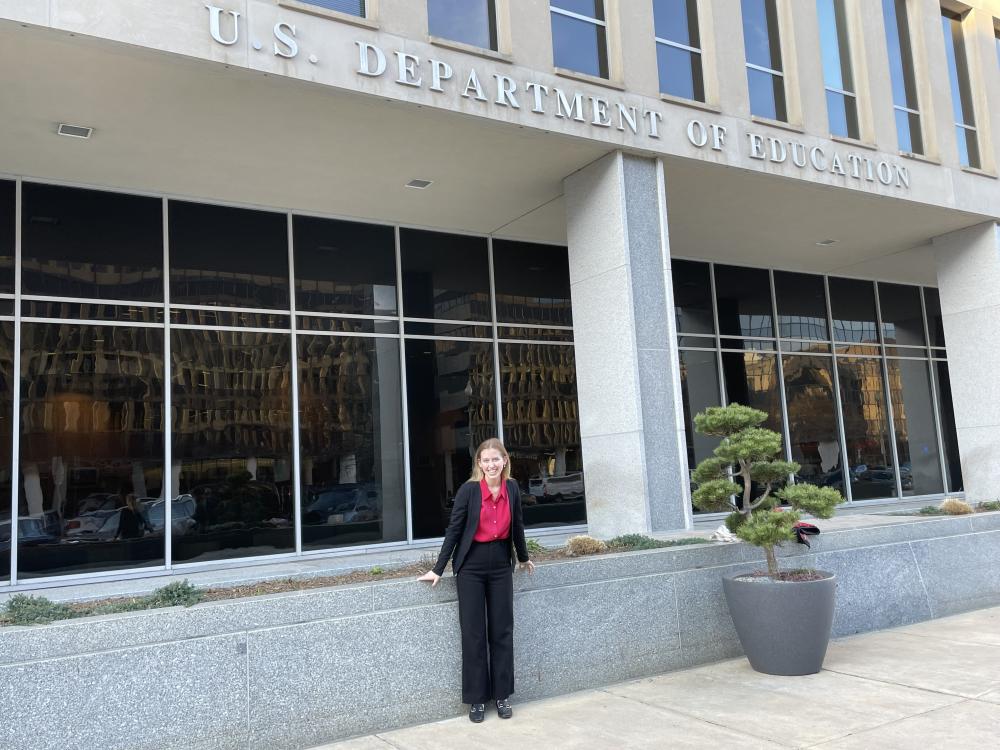 Photo student in front of the U.S. Department of Education's building