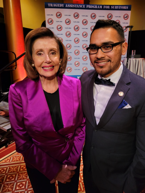 Christopher Rojas standing next to former Speaker of the House Nancy Pelosi at an event.