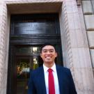 Student intern standing in front of the United States Department of Commerce building