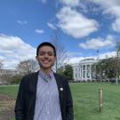 Headshot of Hipolito Angel Cerros in front of the White House lawn