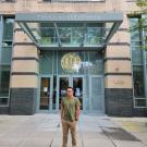 Photo of Christopher Rojas standing in front of a UC building